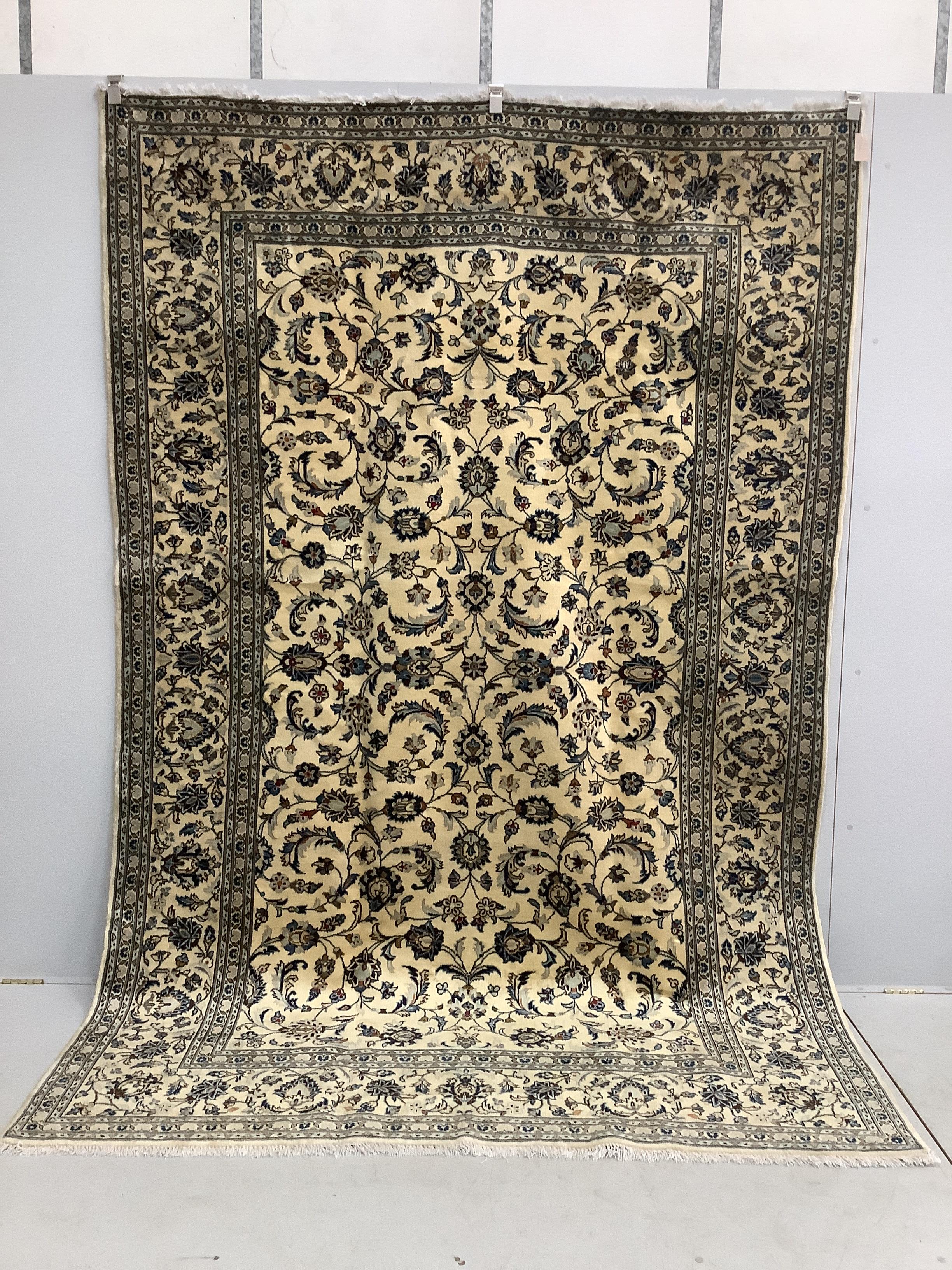 A Kashan ivory ground carpet, 302 x 196cm